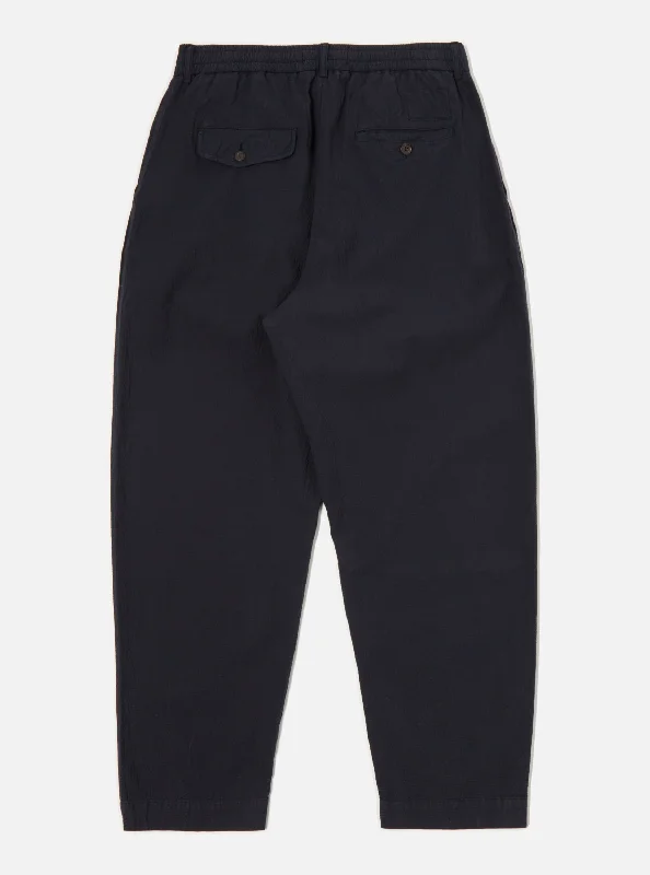 universal-works-pleated-track-pant-in-navy-seersucker-ii