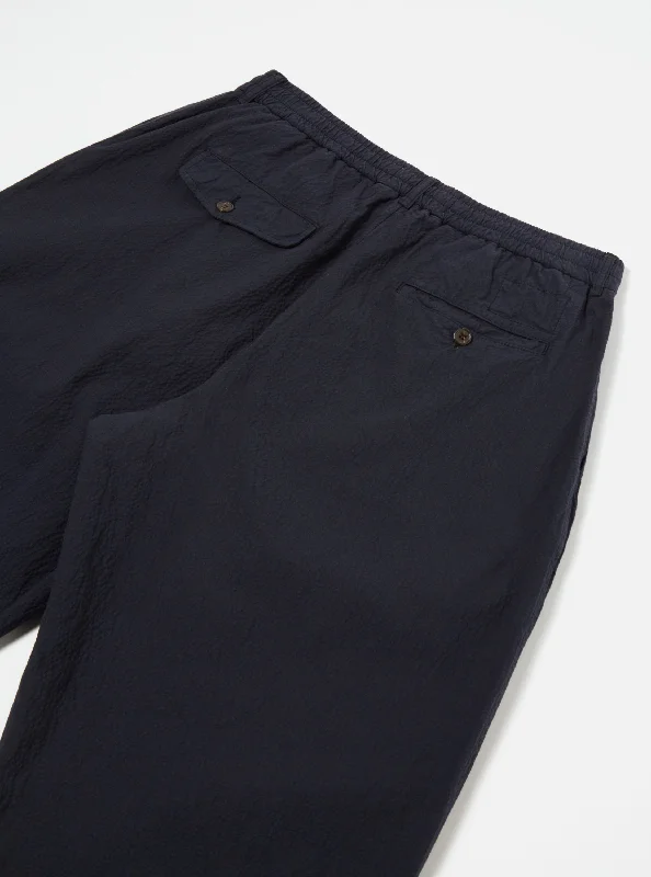 universal-works-pleated-track-pant-in-navy-seersucker-ii